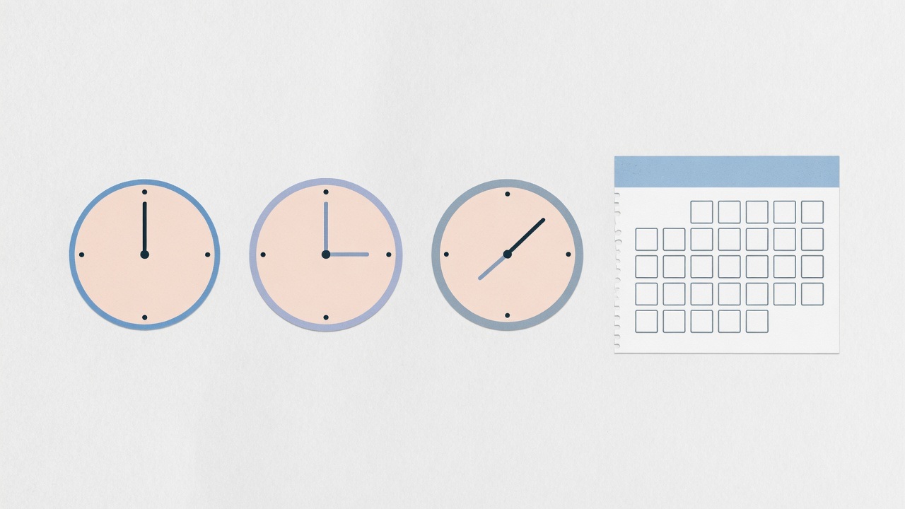 Three abstract clocks beside a blank calendar